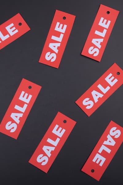Sale tags scattered on a dark surface